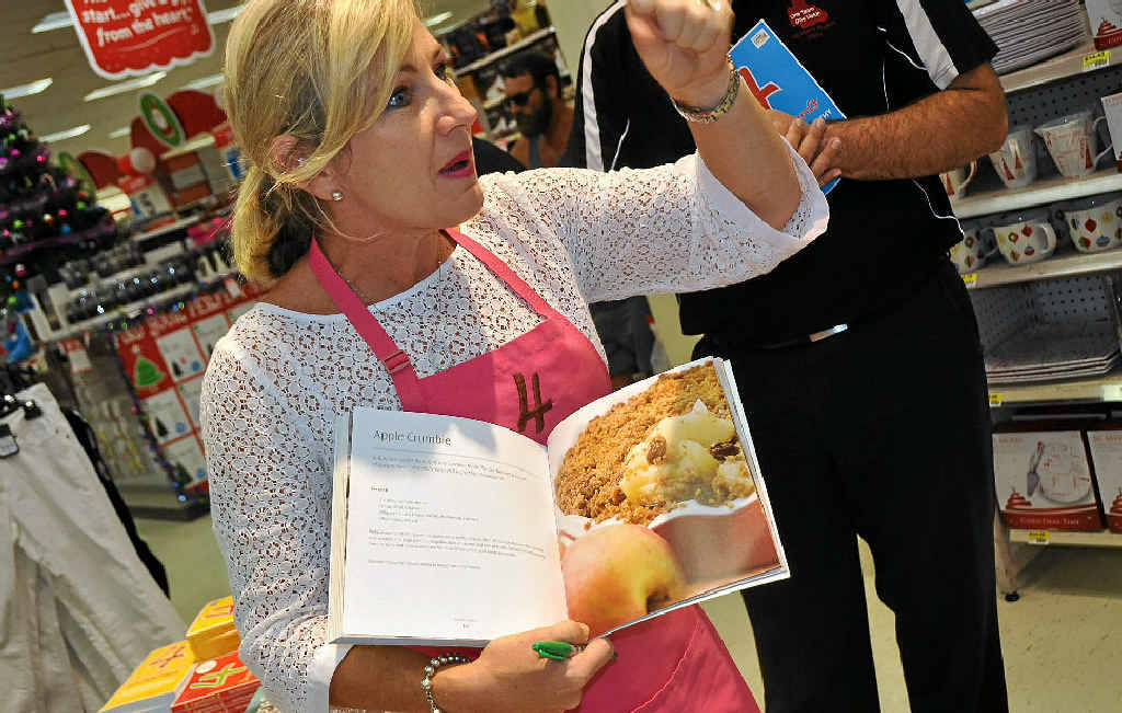 Author Kim McCosker shows crowds a recipe in one of her 4 Ingredients cookbooks that came from her Warwick aunt Lorraine Leeson.